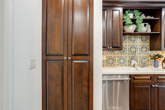 kitchen featuring sink, decorative backsplash, and stainless steel dishwasher