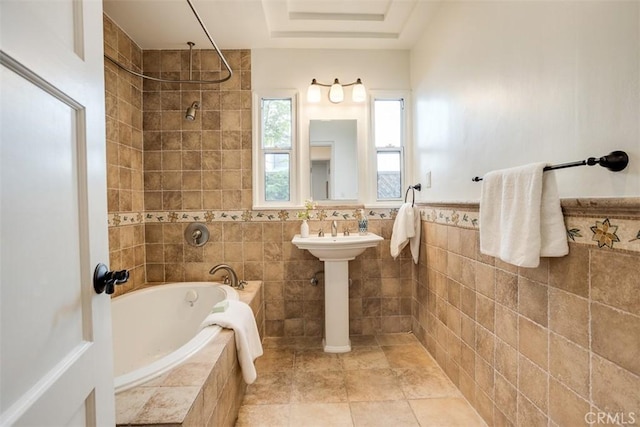 bathroom featuring shower with separate bathtub and tile walls