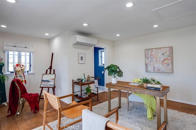 home office featuring wood-type flooring and a wall mounted AC