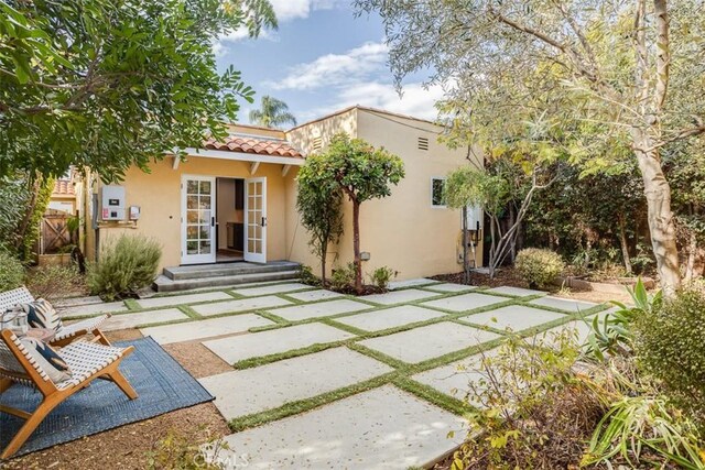 back of property featuring french doors and a patio