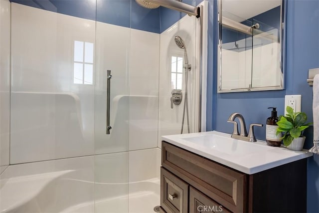 bathroom featuring vanity and a shower