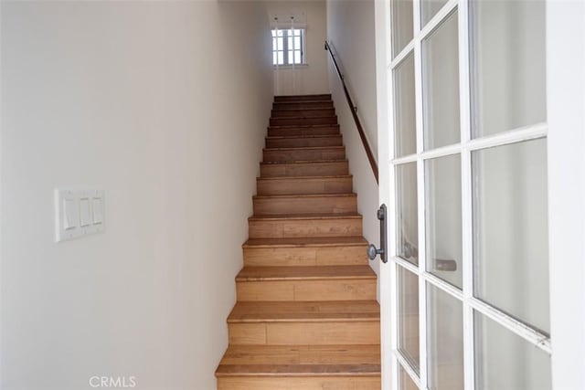 stairs with hardwood / wood-style floors