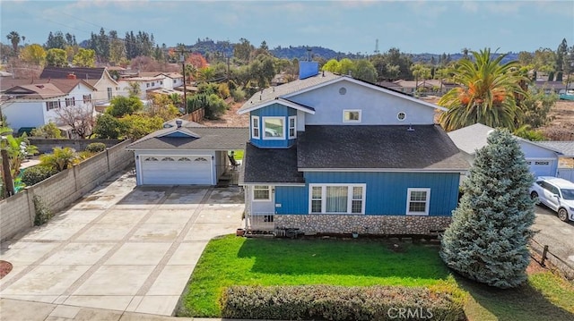 view of front of home with a garage and a front lawn