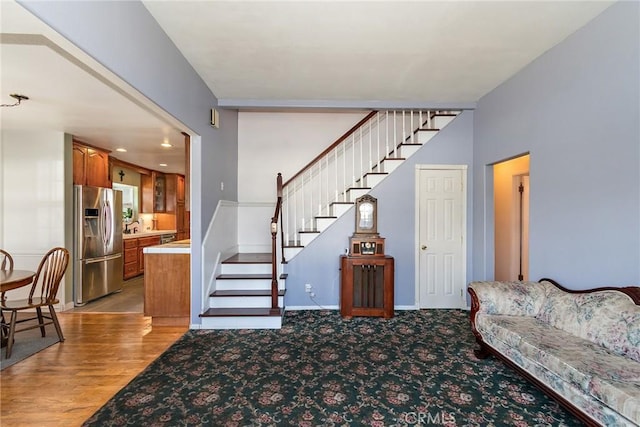 carpeted living room with sink