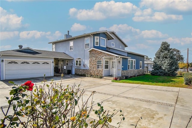 view of property featuring a garage and a front yard