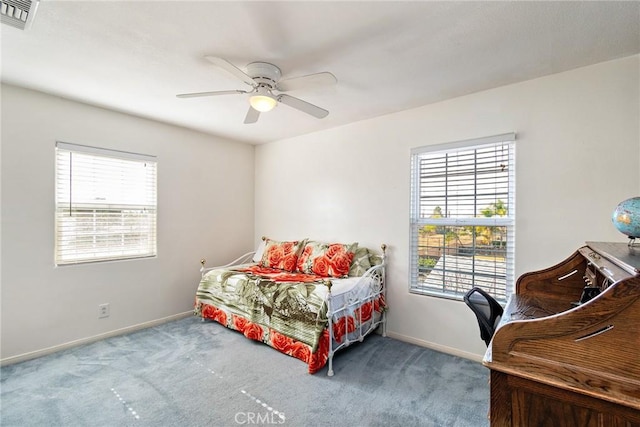 bedroom with multiple windows, carpet floors, and ceiling fan