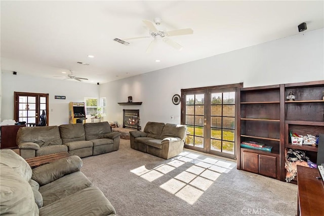 living room featuring light carpet, ceiling fan, and french doors