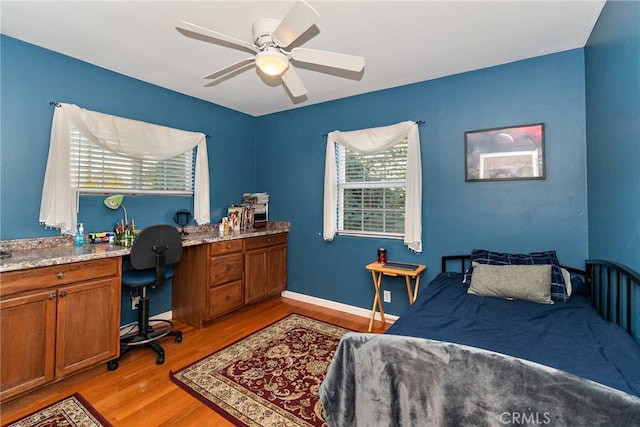 bedroom with light hardwood / wood-style floors and ceiling fan