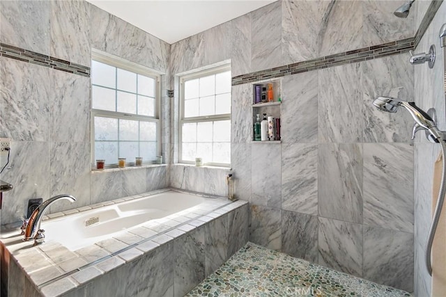 bathroom featuring shower with separate bathtub