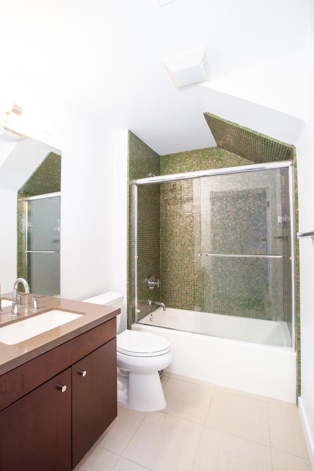 full bathroom featuring tile patterned flooring, vanity, bath / shower combo with glass door, and toilet