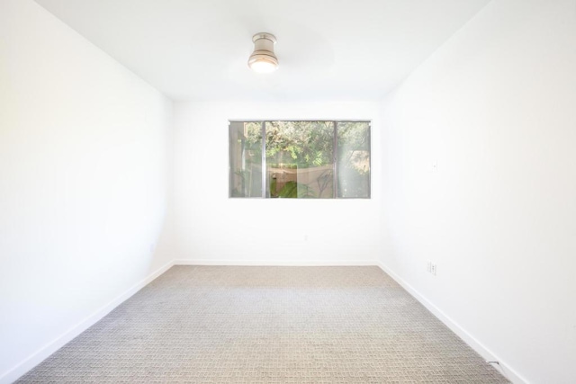 unfurnished room featuring carpet flooring