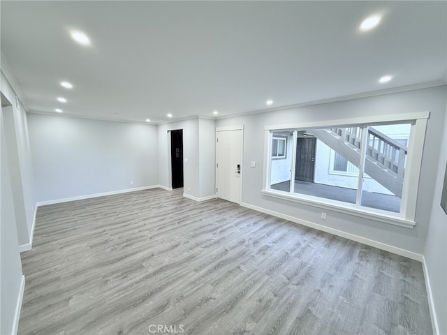 unfurnished room with ornamental molding and light hardwood / wood-style flooring