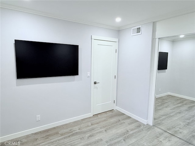 interior space with ornamental molding and light wood-type flooring