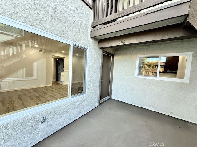 view of patio featuring a balcony