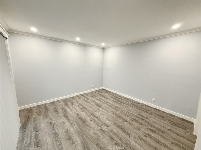 unfurnished room with crown molding and hardwood / wood-style floors