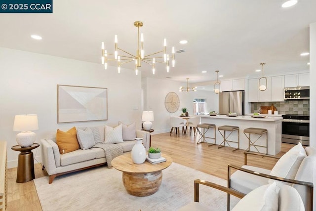 living room featuring light hardwood / wood-style flooring and a chandelier