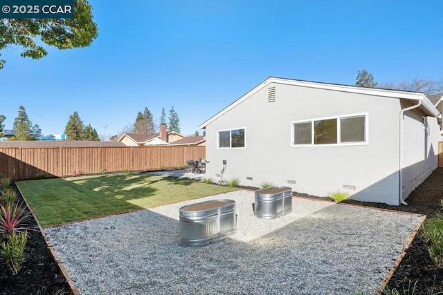 back of property featuring a patio area and a lawn