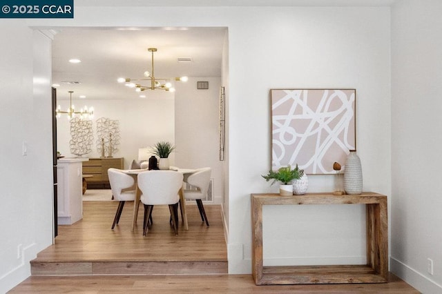 dining room with an inviting chandelier and hardwood / wood-style flooring