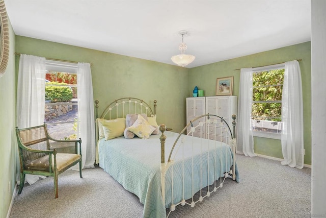 carpeted bedroom with multiple windows