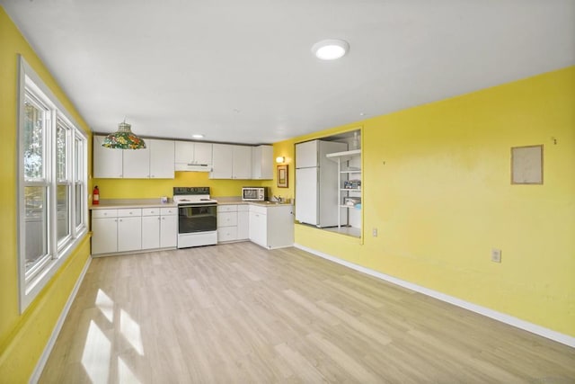 kitchen with white cabinets, white appliances, and light hardwood / wood-style flooring