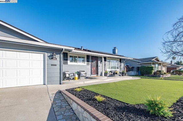 ranch-style house with a garage, a front yard, and solar panels