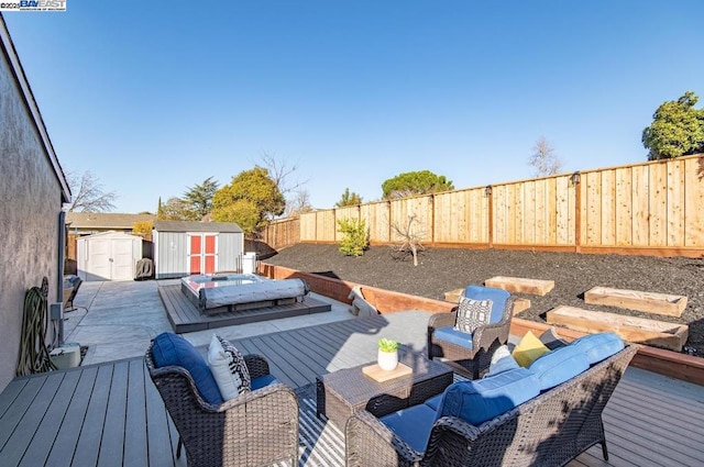 deck featuring an outdoor living space and a shed