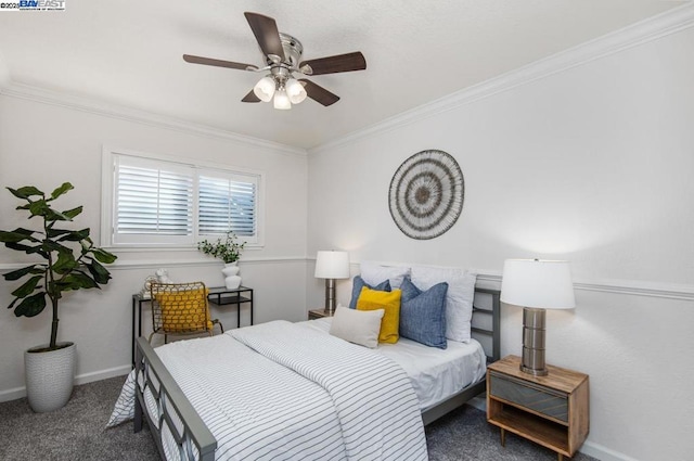 bedroom with dark colored carpet, crown molding, and ceiling fan