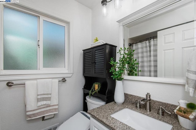 bathroom with vanity and toilet