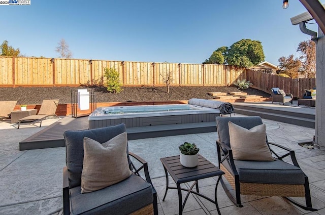 view of patio featuring an outdoor hot tub