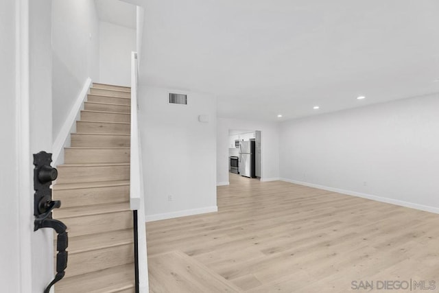 staircase featuring wood-type flooring