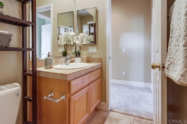 bathroom featuring vanity, toilet, and tile patterned flooring