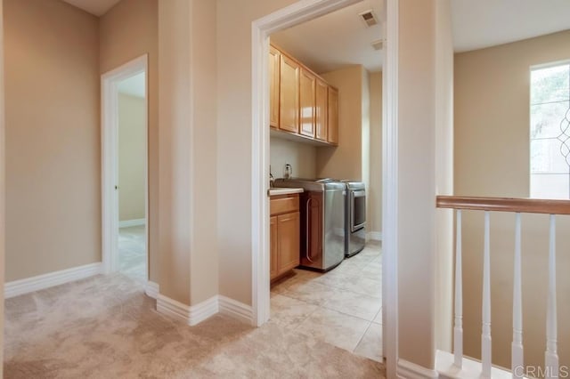 hallway with light carpet and independent washer and dryer