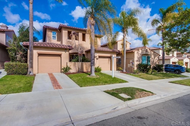 mediterranean / spanish-style home with a garage and a front lawn