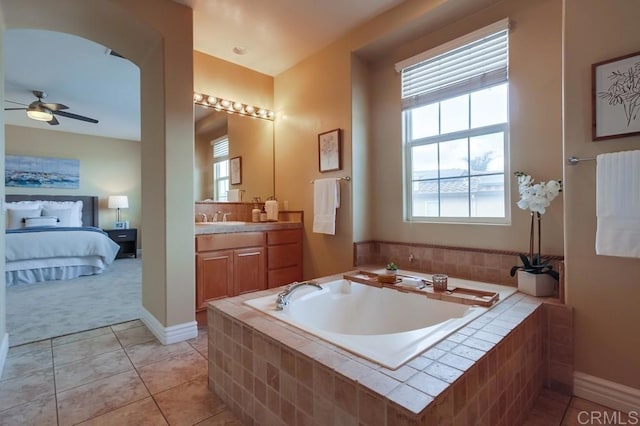 bathroom featuring vanity, tile patterned floors, tiled bath, and ceiling fan