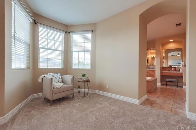 sitting room featuring light colored carpet