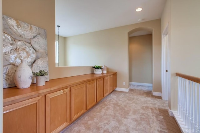 hallway featuring light colored carpet