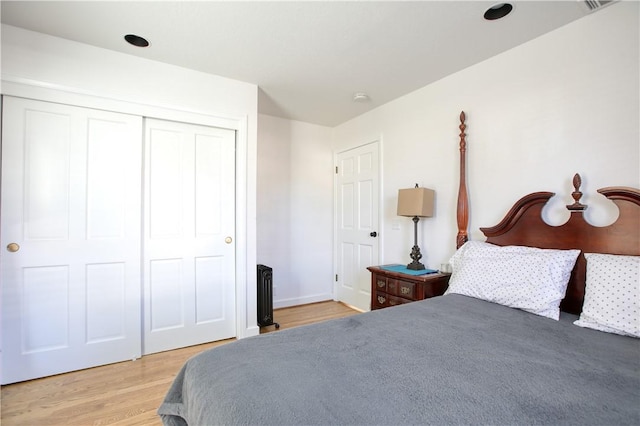 bedroom with hardwood / wood-style floors and a closet