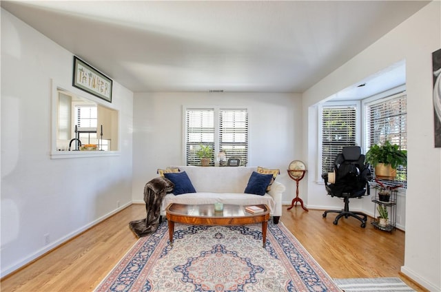 living area with hardwood / wood-style flooring