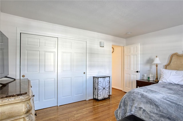 bedroom featuring hardwood / wood-style flooring and a closet