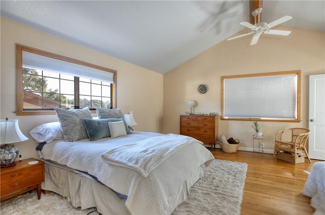 bedroom featuring lofted ceiling, light wood-type flooring, and ceiling fan