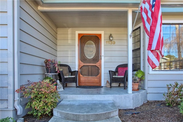 view of exterior entry with covered porch