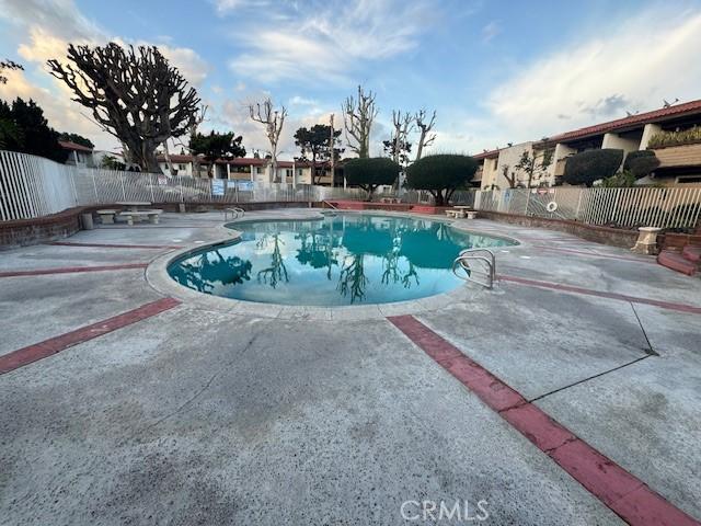 2501 W Sunflower Unit F12, Santa Ana, CA 92704 - community pool with a fenced backyard and a patio area