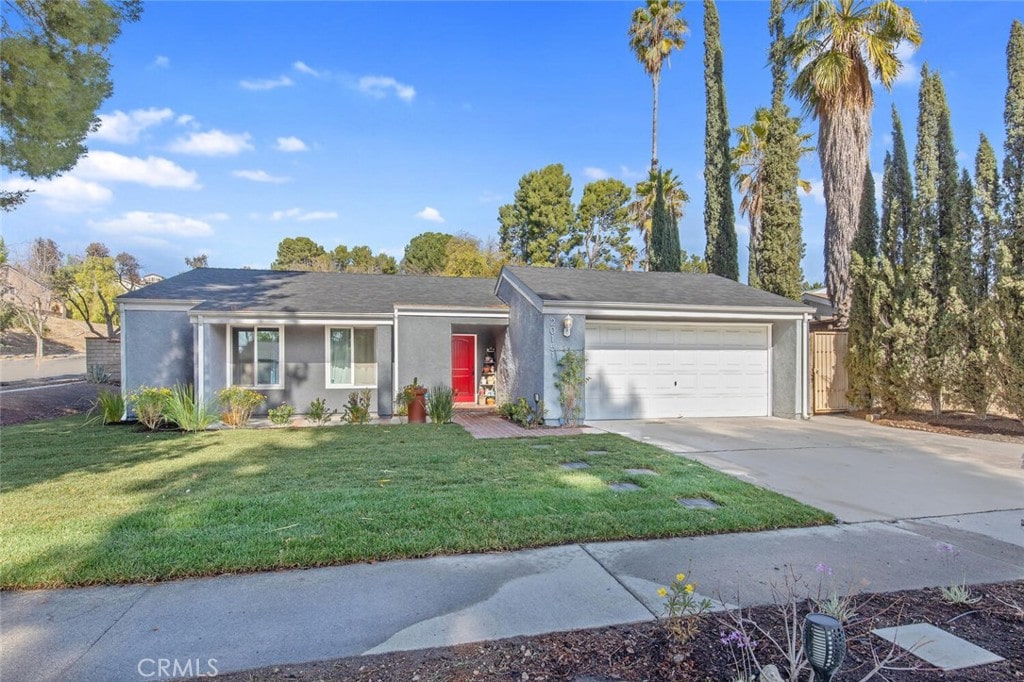 single story home with a garage and a front yard