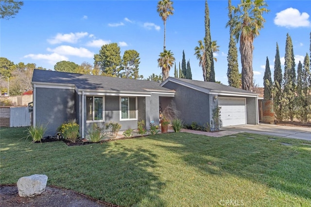 single story home featuring a garage and a front yard