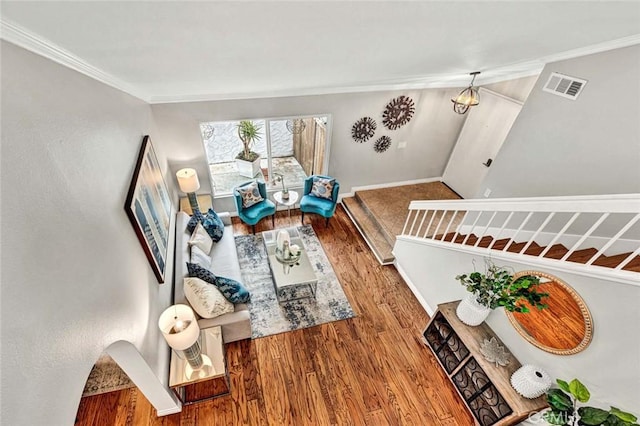 living room featuring crown molding and wood-type flooring