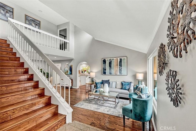 living room featuring high vaulted ceiling and light wood-type flooring