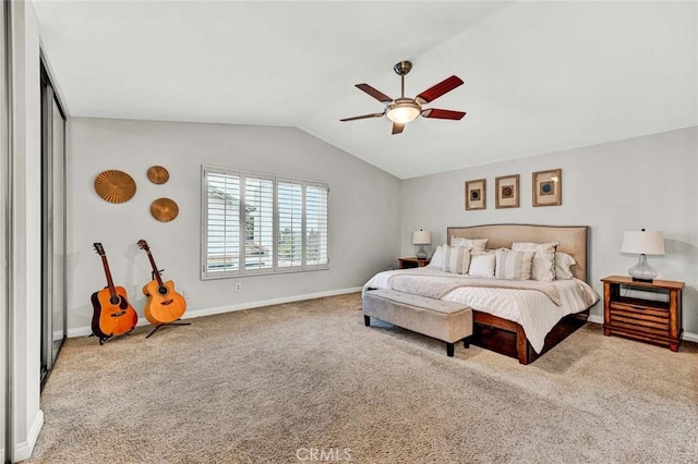 bedroom with vaulted ceiling, ceiling fan, and carpet floors