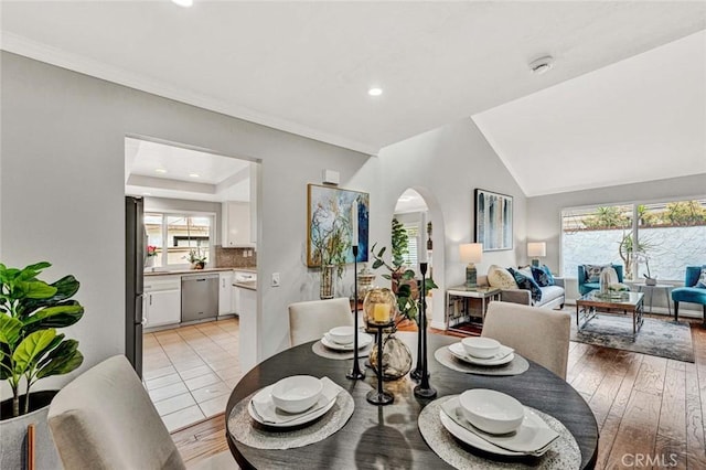 dining area featuring lofted ceiling and light hardwood / wood-style flooring