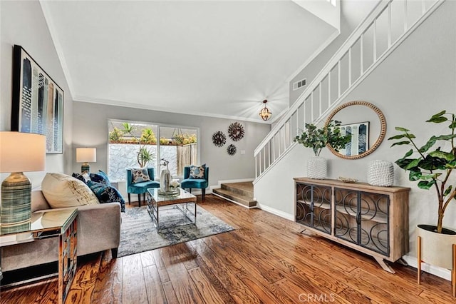 living room featuring wood-type flooring and crown molding