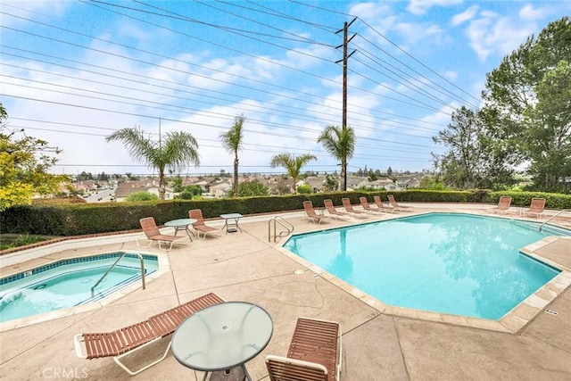 view of pool featuring a patio area and a hot tub